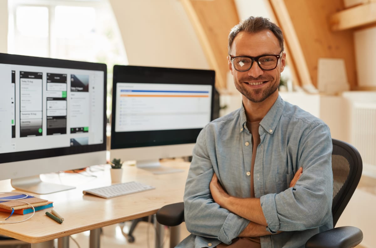 Loan officer at a workstation with a lending dashboard on screen