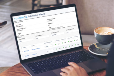 hand on computer with fundingo submission wizard