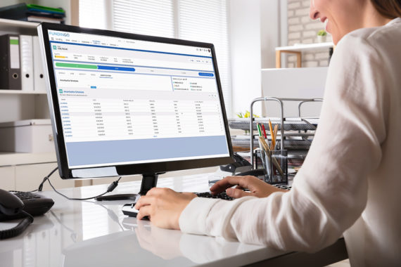 Young Businesswoman Working On Computer With Fundingo Loan Origination software